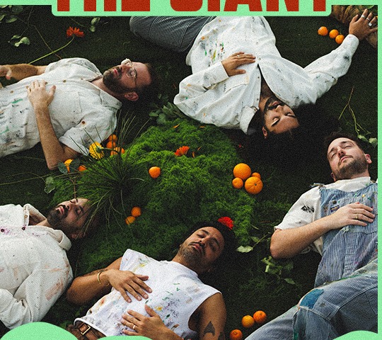 Young the Giant band members lying on moss surrounded by oranges